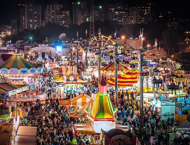 Overhead shot of the Western Fair with rides and attractions lightihng up the night sky