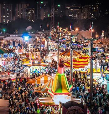 Overhead shot of the Western Fair with rides and attractions lightihng up the night sky