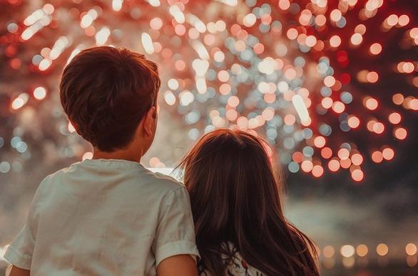 young kids looking at fireworks in the sky