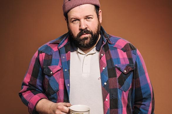 Musician Donovan Woods holding a coffee cup