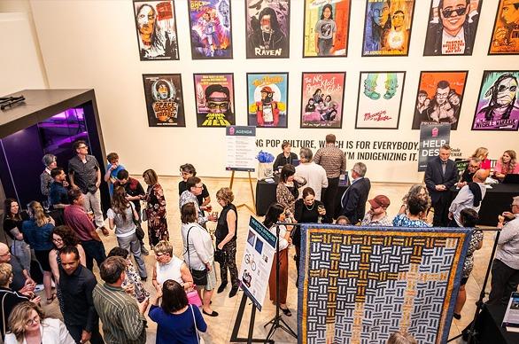 A large group of people gathered at Museum London for an exhibition event