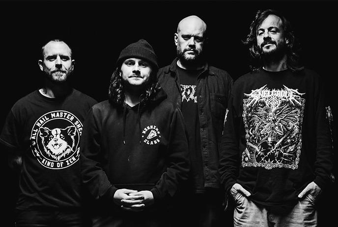 A black and white shot of the 4 band members of the Cancer Bats.