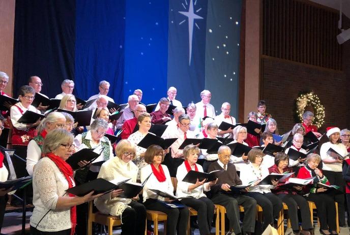 The Forest City Singers performing on stage.