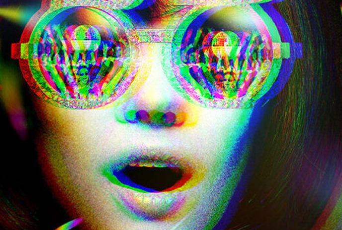 A vibrant, glitch-style image of a woman with open mouth wearing round glasses reflecting colorful faces.