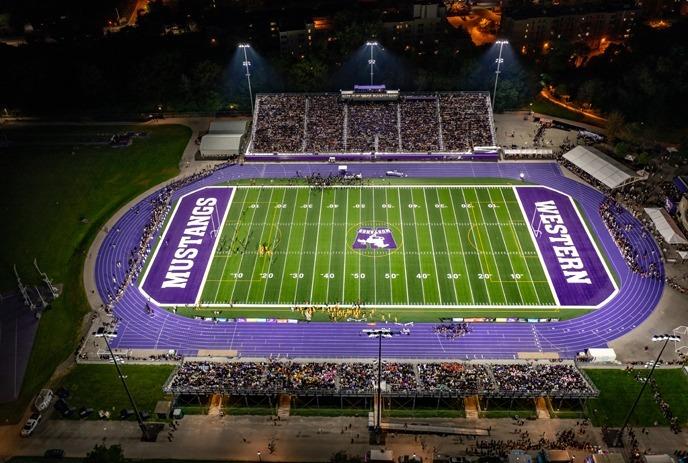 Western Alumni Stadium during an evening football game.