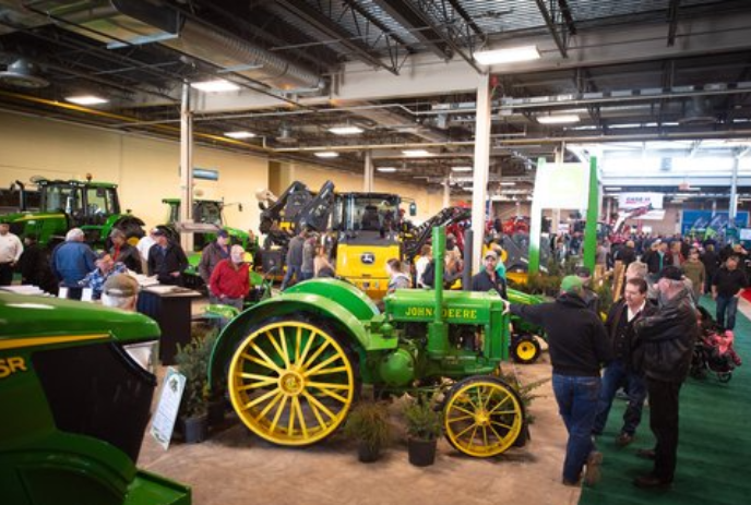 People looking at John Deere tractors at a previous show.