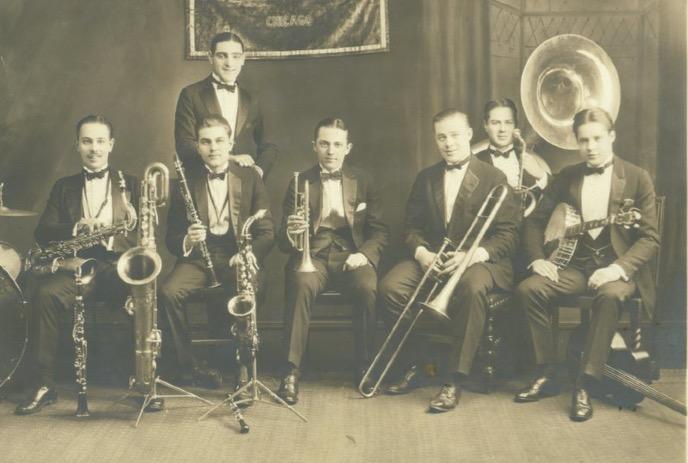 An old-time photo of people from the 1920's practicing their musical instruments.