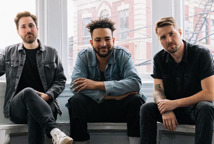 Three members of the band Texas King sitting in front of a window