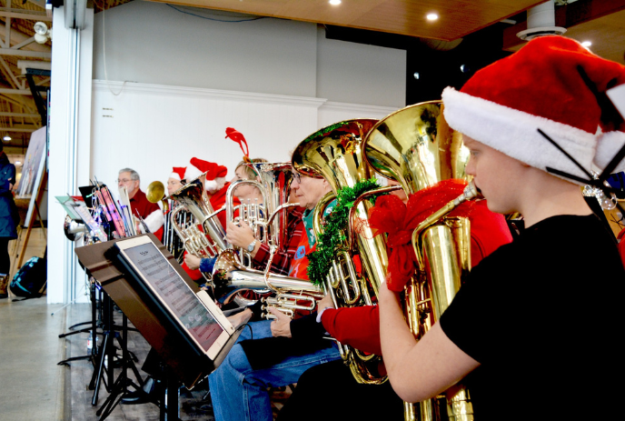 Group of people on stage playing their tubas.