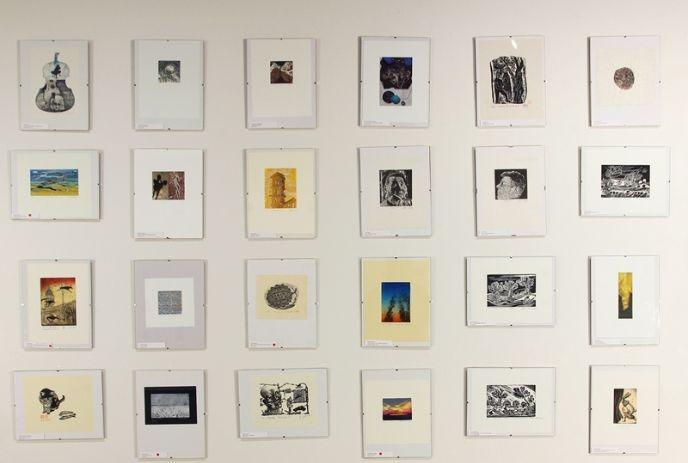 Miniature paintings displayed on a wall.