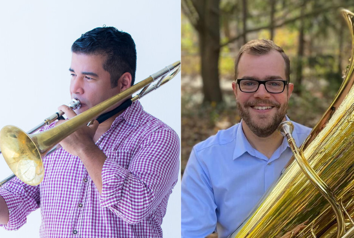 Two individuals playing brass instruments, smiling and posing for the picture.