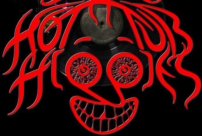 Red stylized text forming a face with two vinyl records as eyes and a wide, toothy grin on a black background.