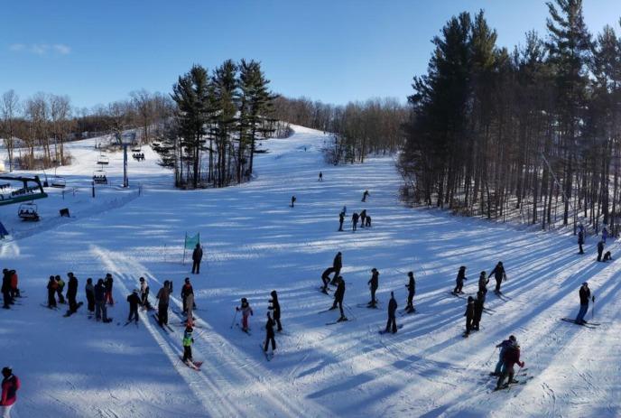 Skiers and snowboarders on the snowy slopes of Boler Mountain.