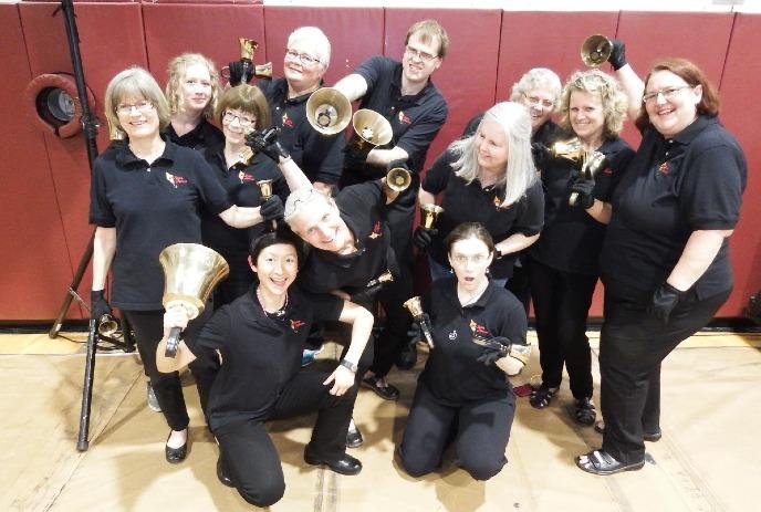 A group of people posing with bell type instruments.