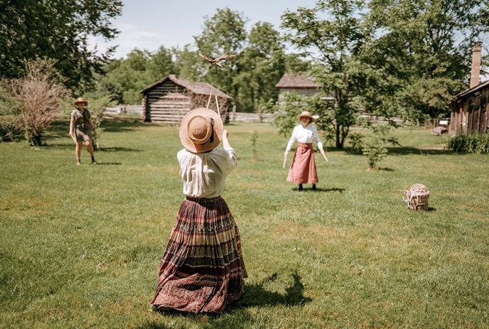 historic actors playing a game outdoors at Fanshawe Pioneer Village in London, Ontario