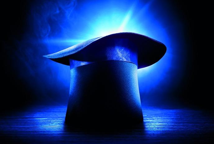 A spotlight shines on a magician's hat with images of nine speakers along the left and bottom, featuring a circus tent logo.