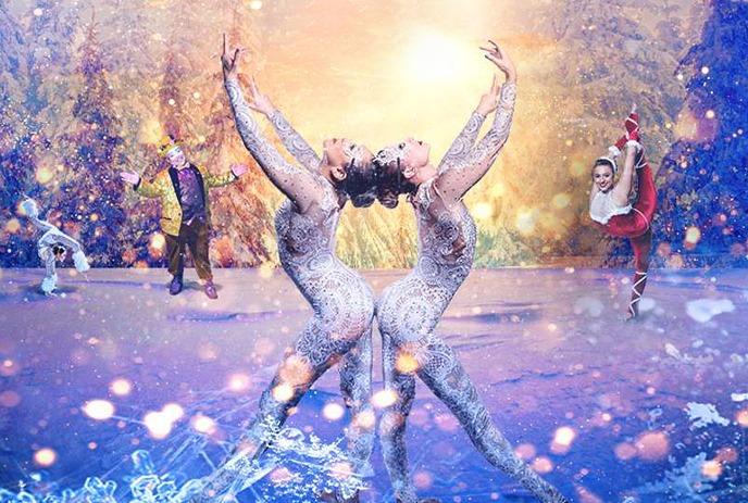 Figure skater, snowboarder, skier, and Santa Claus performing in a winter sunset scene with snowflakes.