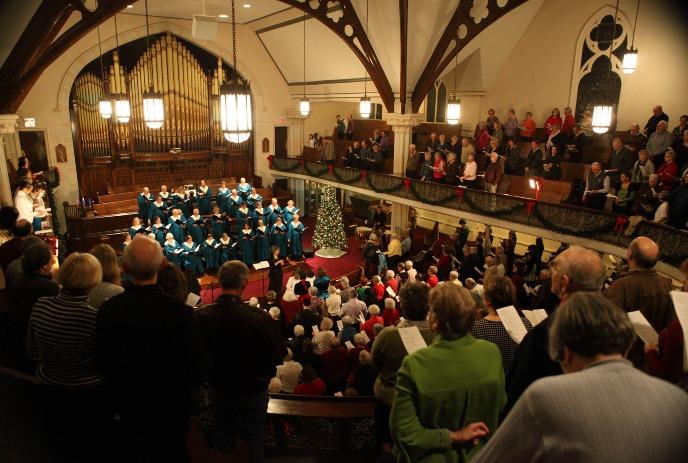 Wesley-Knox UC Choirs performing the Silent Night, Holy Night concert in a festively decorated church.