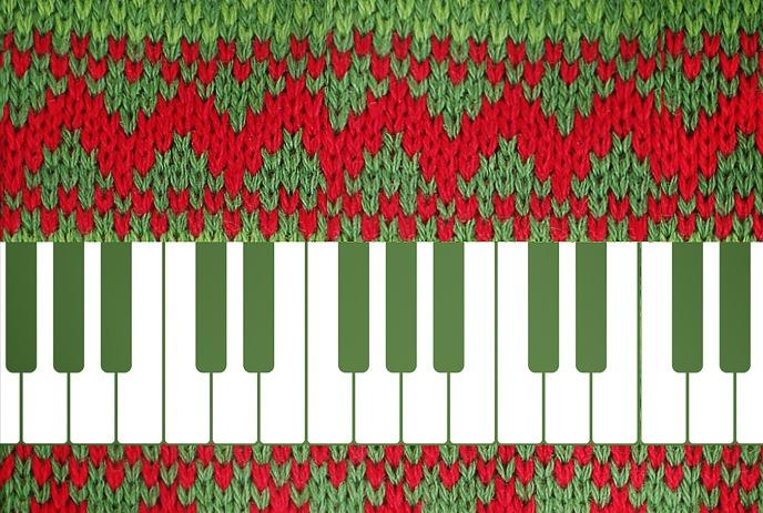 A knitted Christmas sweater in green and red colors with a piano keyboard design at the bottom.