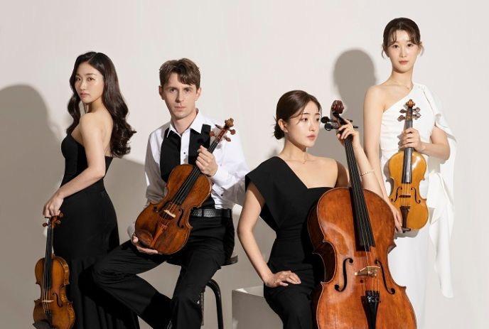 The Esmé Quartet posing with their instruments in front of a white background.