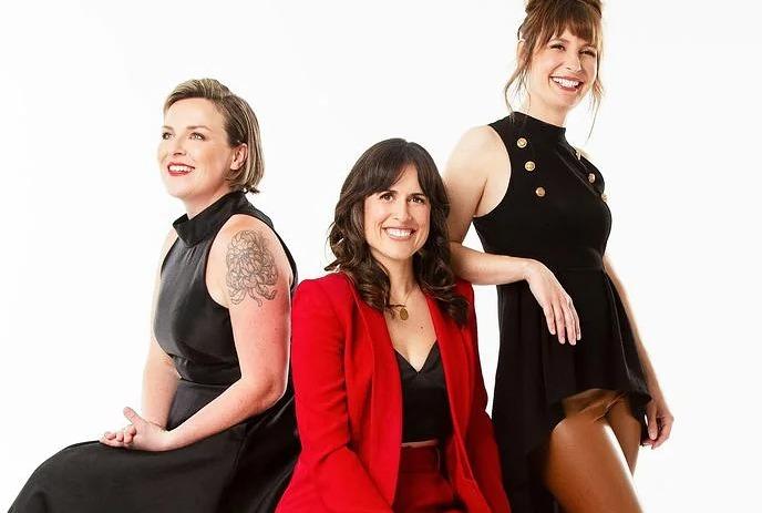 The 3 band memebers of the Good Lovelies, posing together in front of a white background.