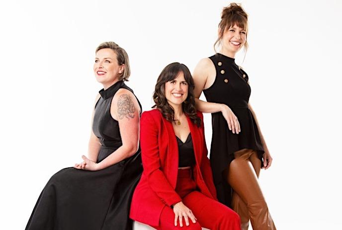 The 3 band memebers of the Good Lovelies, posing together in front of a white background.