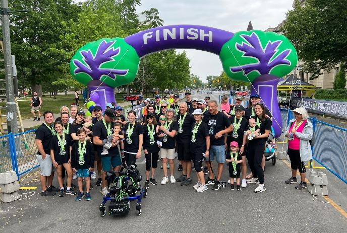 A crowd at the finish line of a Forest City Road Races, posing for the camera.