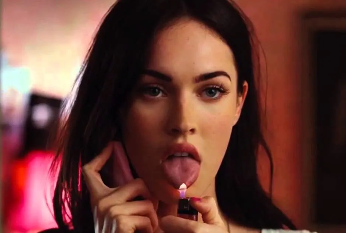 Megan Fox from Jennifer's Body holding a lighter up to her tongue.