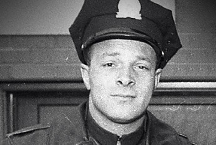 A black and white picture of Lewis Coray in the uniform under a white background.