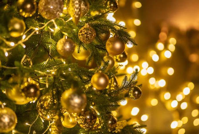 Colorful Christmas balls and snowflakes on a blue background, creating a festive holiday atmosphere.