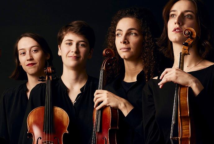 Four performing artists, each holding a string instrument: cello, two violins, and viola under a dark background.