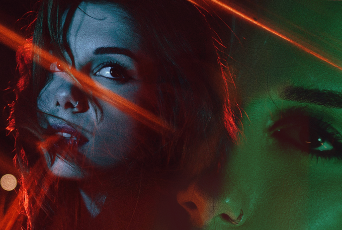 A digitally manipulated portrait of a woman with dramatic lighting, double exposure, and neon streaks.