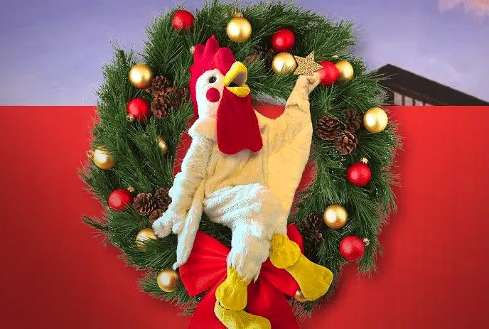 Cornelius Rooster in the middle of a holiday wreath with a red background.