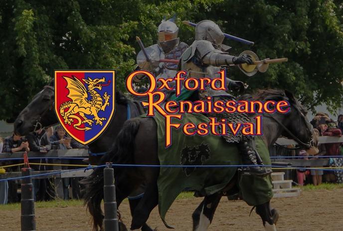 A dynamic scene at the Oxford Renaissance Festival featuring a knight in full armor riding a dark horse.