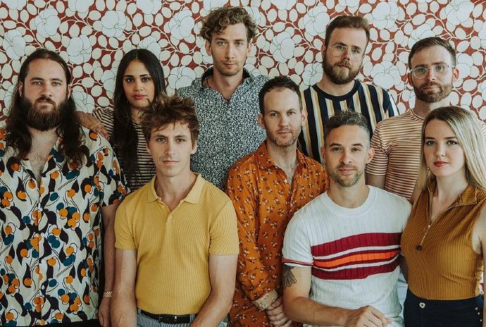 Dwayne Gretzky band members posing together in front of a textured wall.