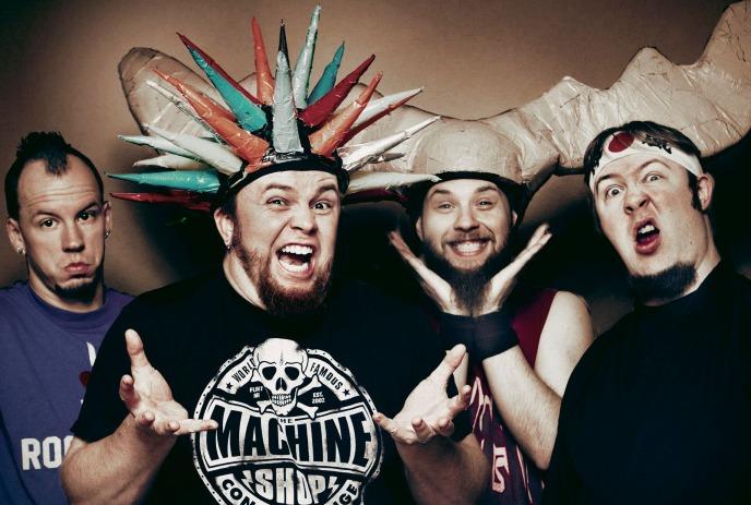 The band Psychostick poses together, featuring members wearing quirky costumes with horned and spiked headpieces.