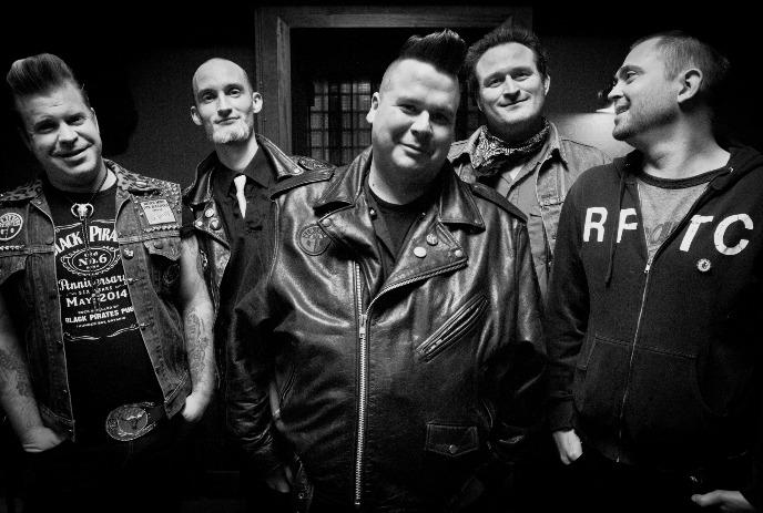 A black and white photo of the 5 members of Raygun Cowboys , posing for the camera, smiling.