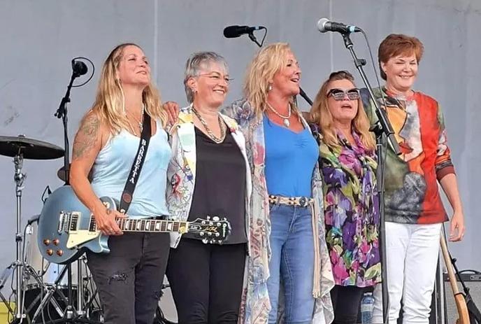 Four female members of the band SheWolves of London on stage