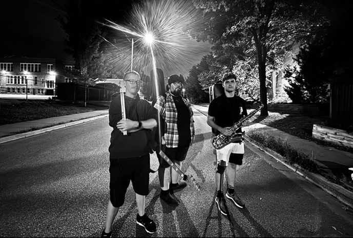 A black and white photo of the band members of Skynet, outside in the street.