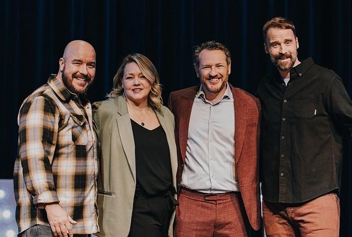 Erica Sigurdson, Pete Zedlacher. Dan Quinn and Paul Myrehaug standing on stage together, smiling.