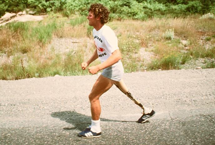 Terry Fox running on a paved road