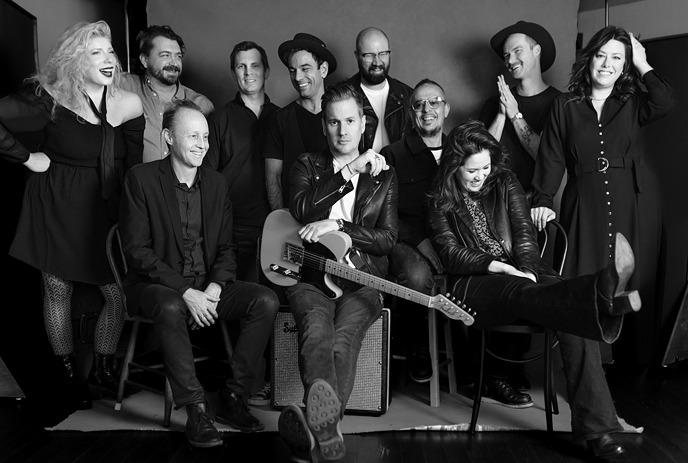 A black and white photo of the 11 members of the Tommy Youngsteen band, posing together for a photo.