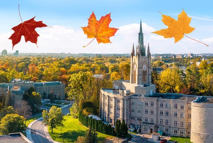 An aerial shot of Western University in the fall, with a red, orange, and yellow leaf at the top of the picture.