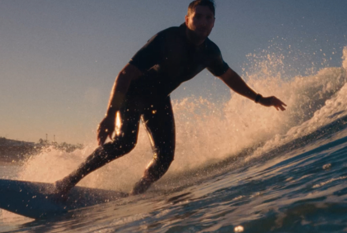 Person surfing a big wave on the water.