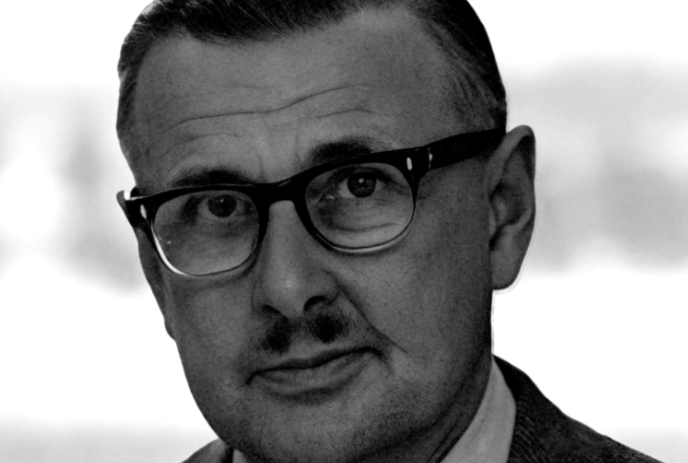 Black and white image of Dennis Alsop wearing glasses.