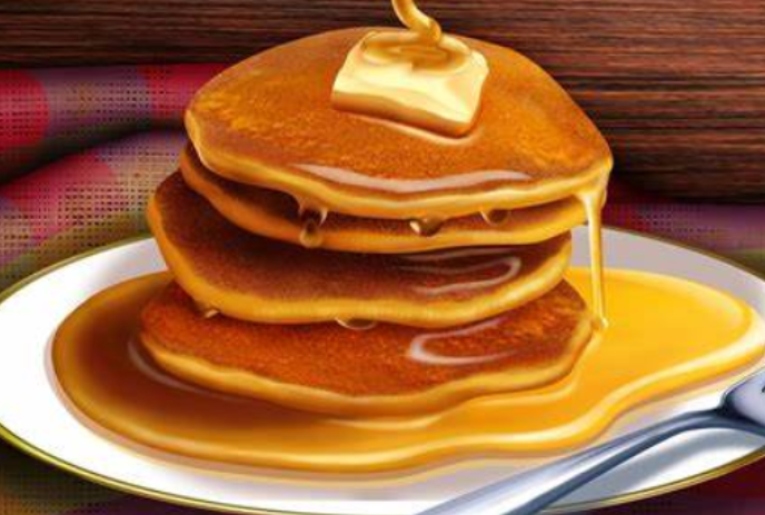 Stack of pancakes with butter and syrup.