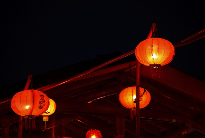 Chinese lanterns glowing in the dark.