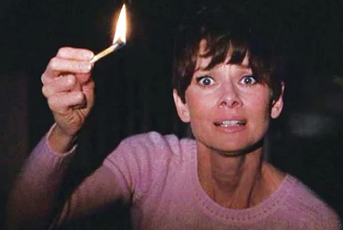 A lady holding lit matchstick, emphasizing anonymity, horror mystery in a dark background.