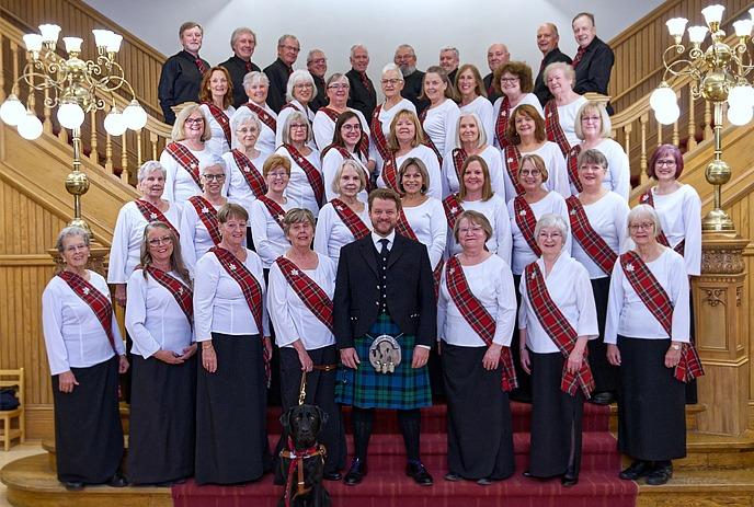 A large group of singers from the Canadian Celtic Choir assembled on a staircase posing for a photo