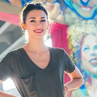 Meaghan Claire Kehoe standing in front of mural